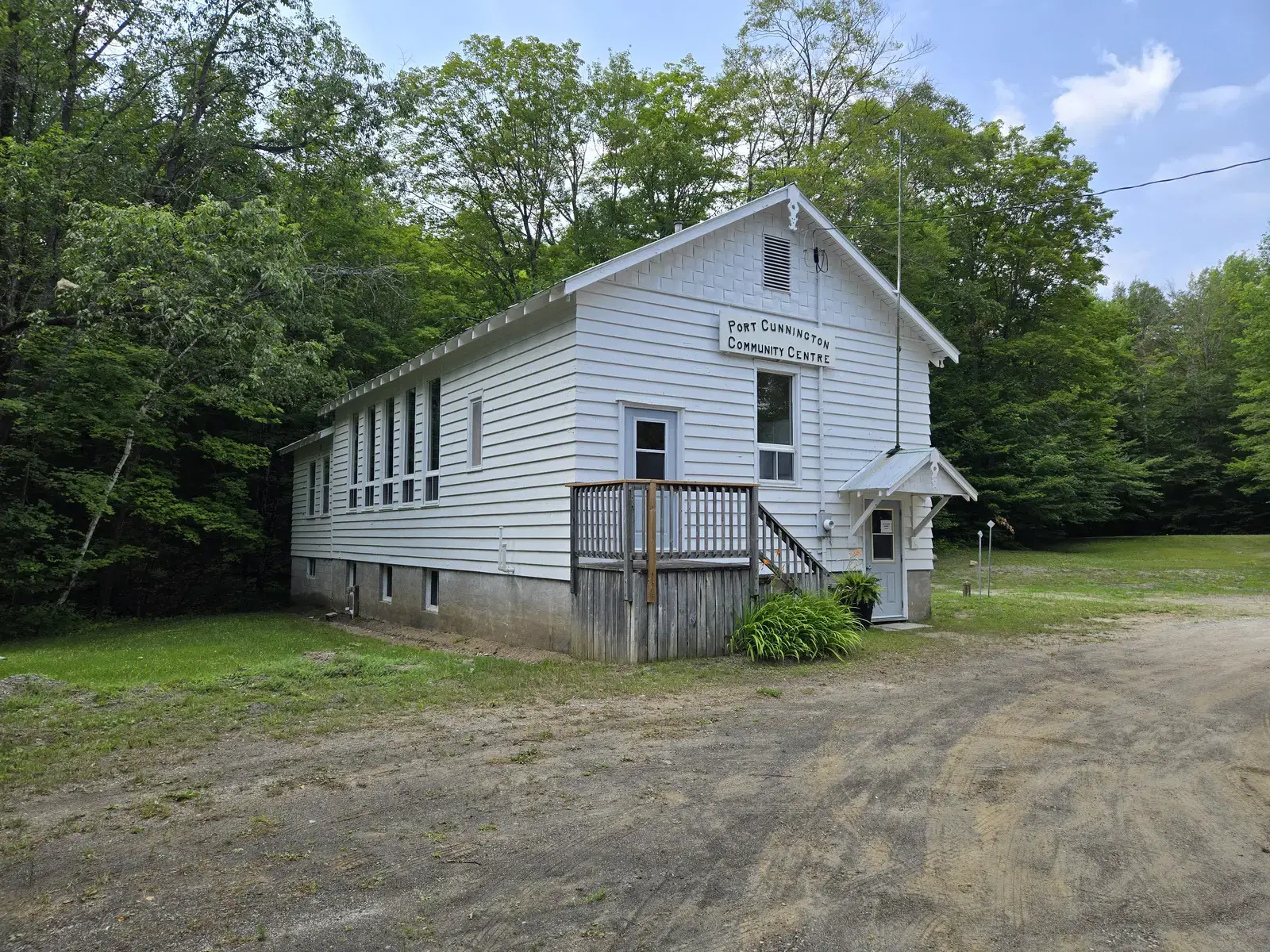 The rear of the hall, showing the later extension under its green metal roof joined to the original building.